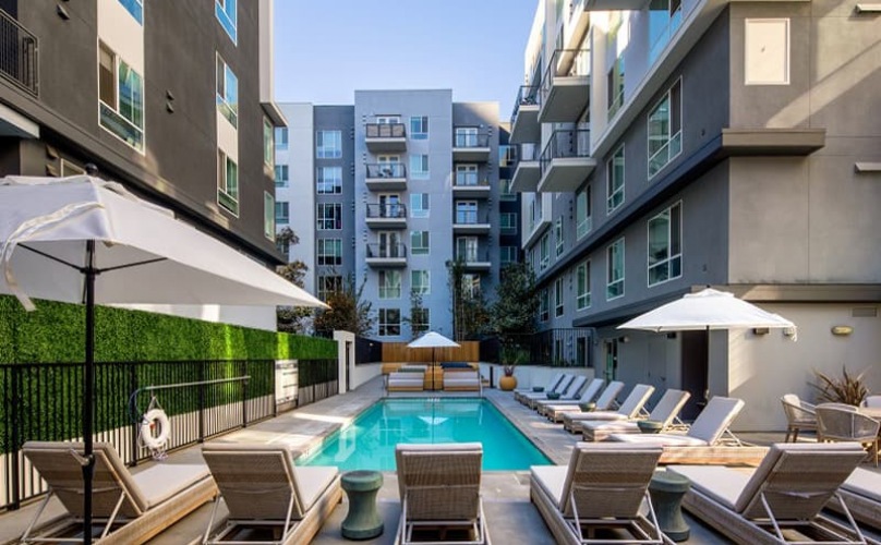spacious swimming pool with ample reclining seats, closeness to property & lush landscaping