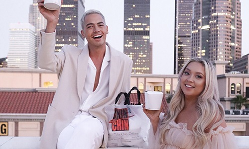 friends enjoying a drink on the roof smiling