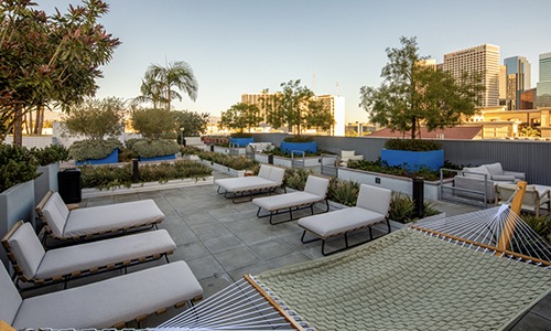swimming pool with comfortable seating and hammock